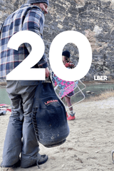 Burt's Tank Top: 20 Pound Propane Tank Insulator and Carrier in use by a person outdoors.