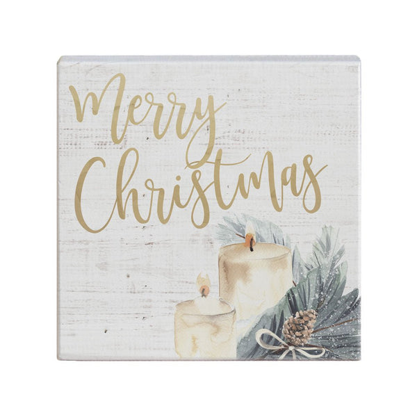 Merry Christmas decor featuring candles and greenery, perfect for festive holiday ambiance.