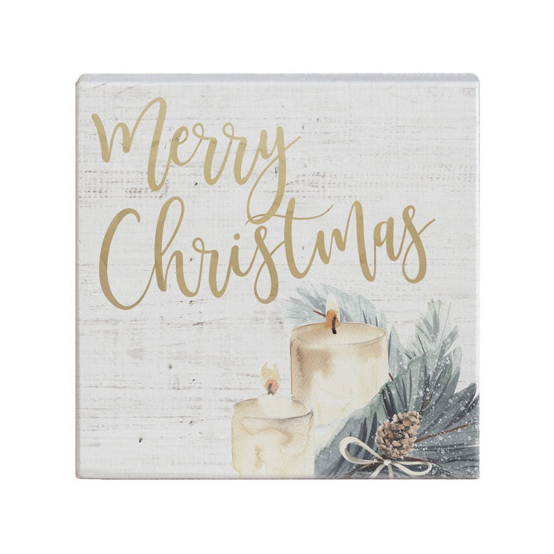 Merry Christmas decor featuring candles and greenery, perfect for festive holiday ambiance.